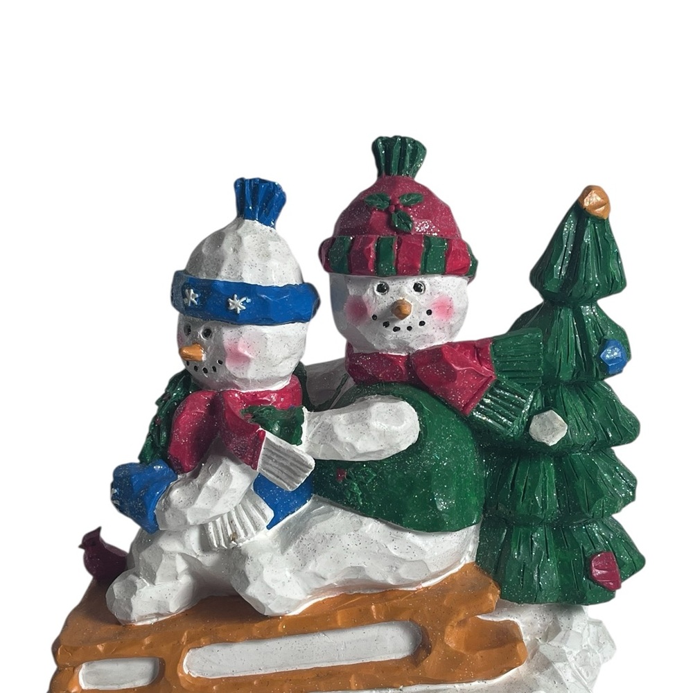 Festive Snowman Sledding Figurine